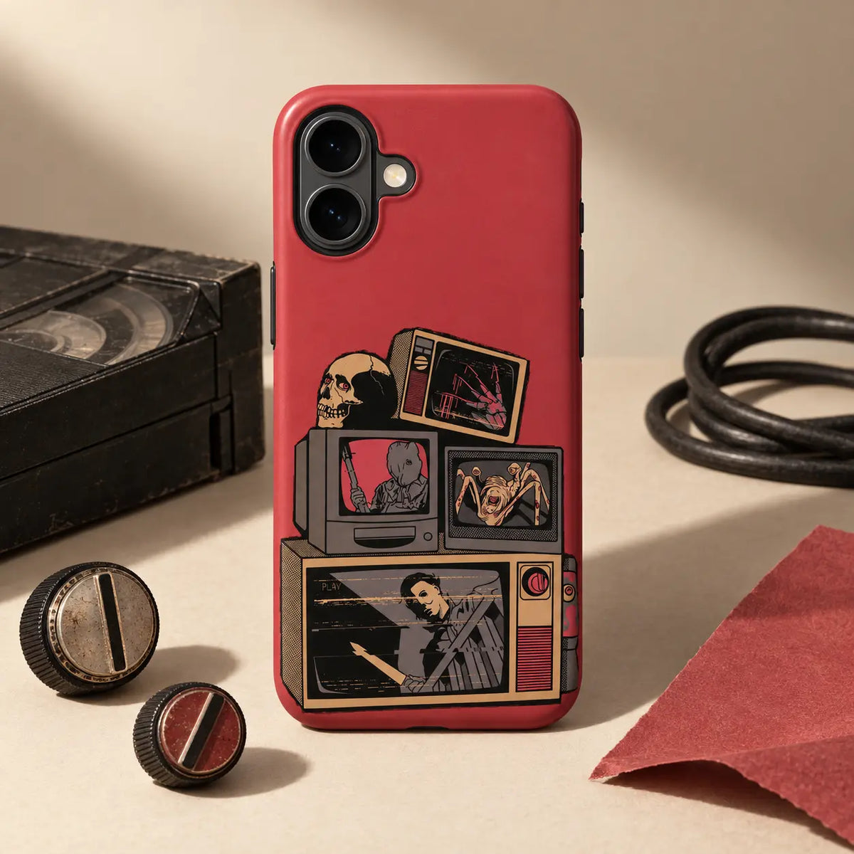 Retro Horror TV phone case displayed with VHS and vintage props