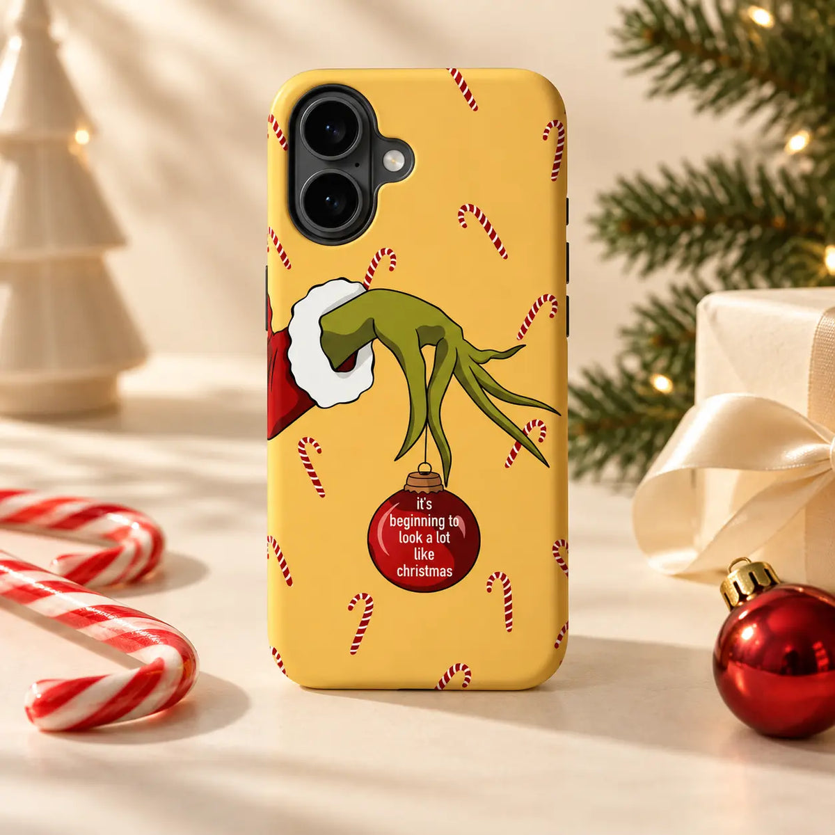 Christmas phone case displayed with candy canes and festive ornaments