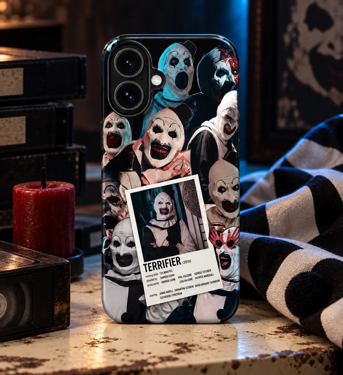Terrifier horror clown phone case displayed in a cinematic tabletop setting