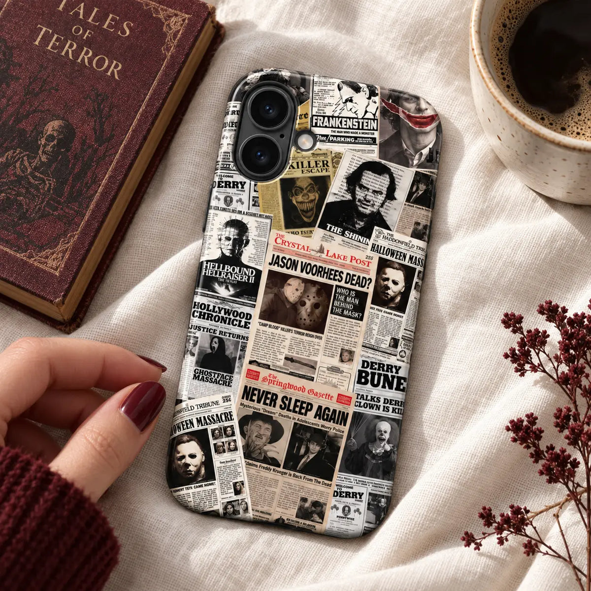 Vintage horror newspaper iPhone case displayed on warm white linen