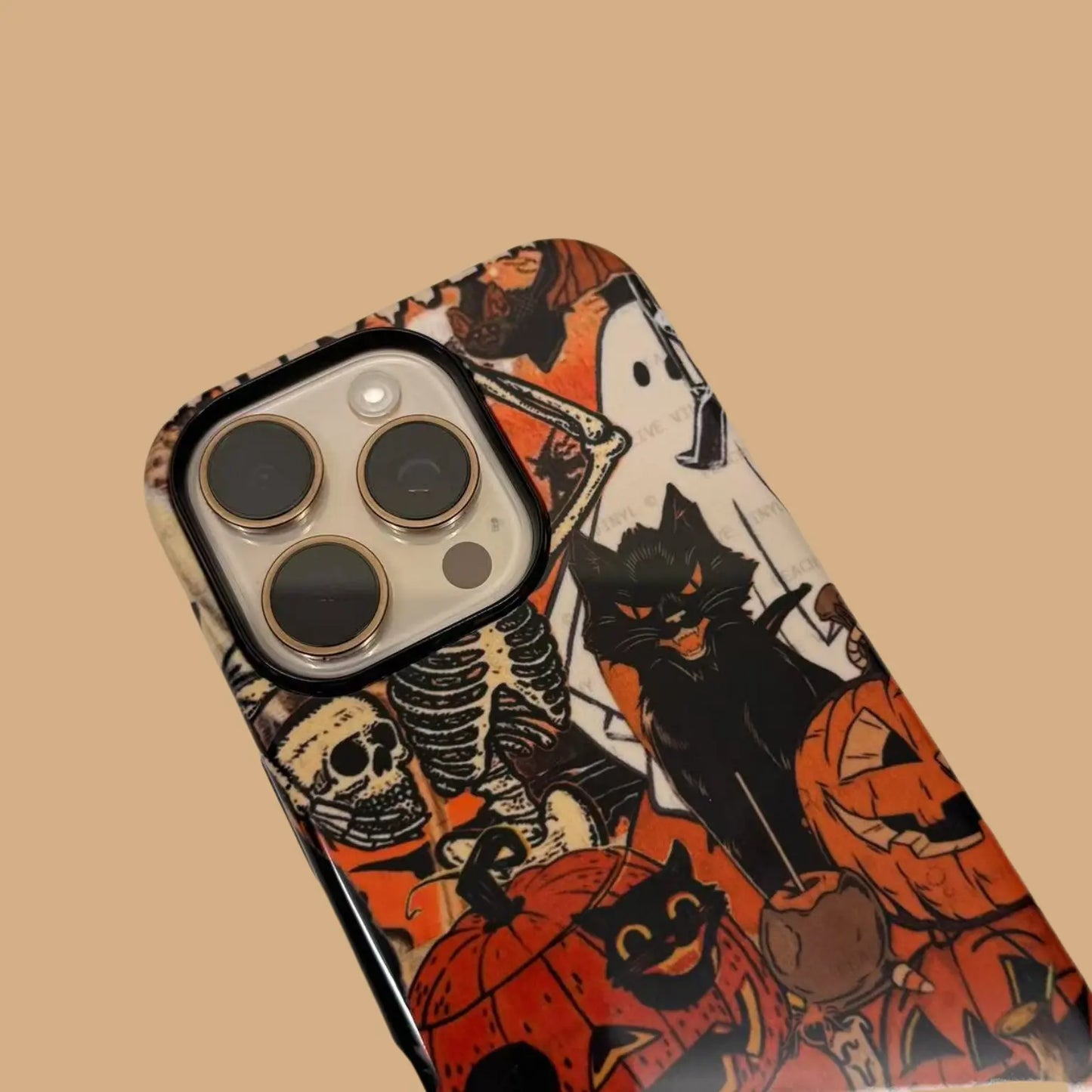 This Halloween phone case features a vintage collage of classic elements like pumpkins, black cats, and skeletons, adding a unique festive vibe.