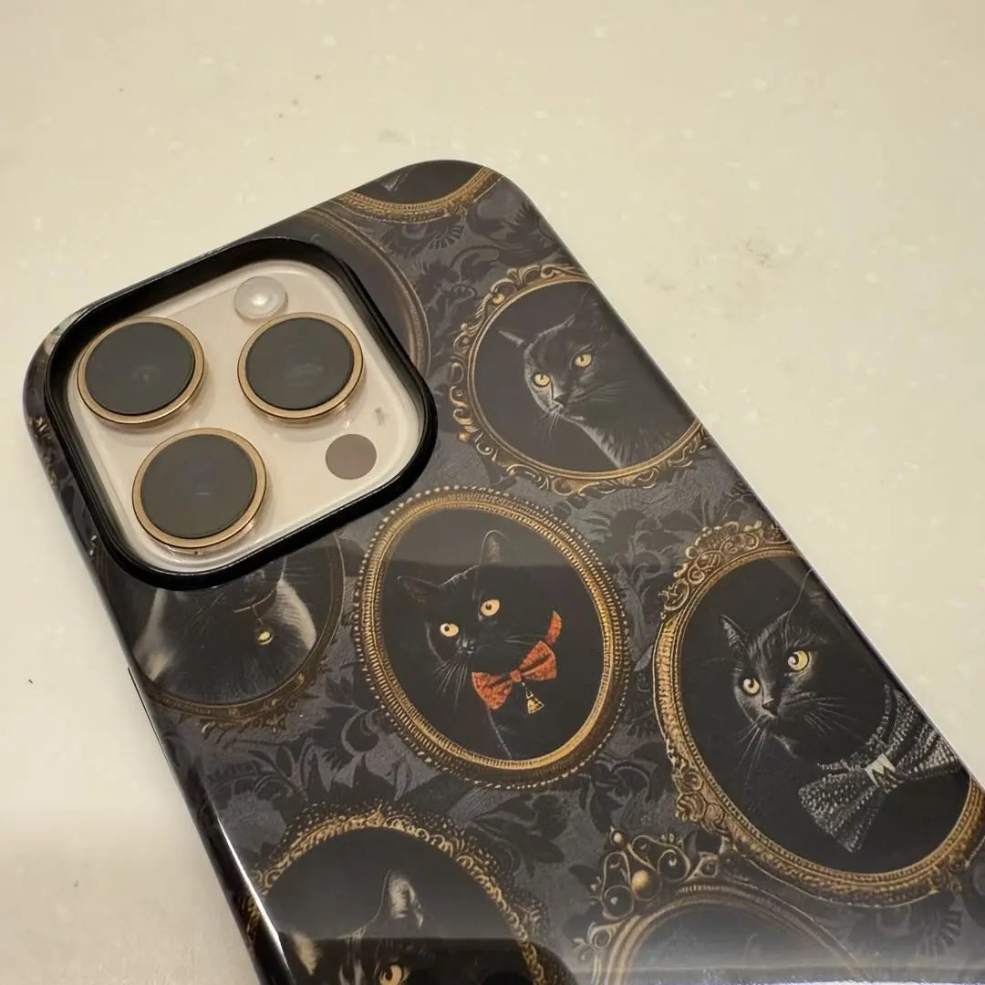 This Halloween phone case features a vintage-inspired design with black cats in ornate frames, blending Gothic aesthetics with a touch of spooky mystery.