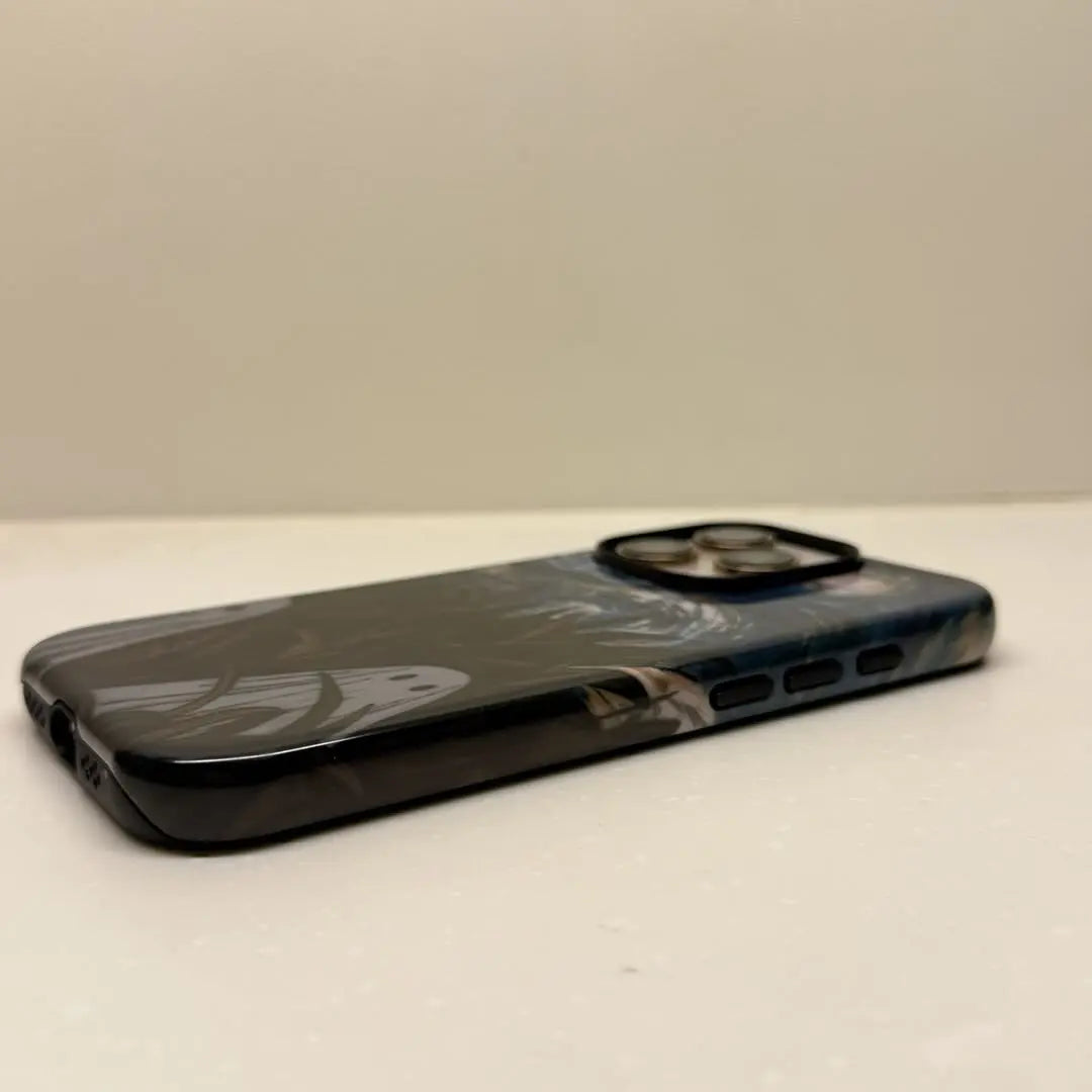 This Halloween phone case features a vintage collage of classic elements like pumpkins, black cats, and skeletons, adding a unique festive vibe.