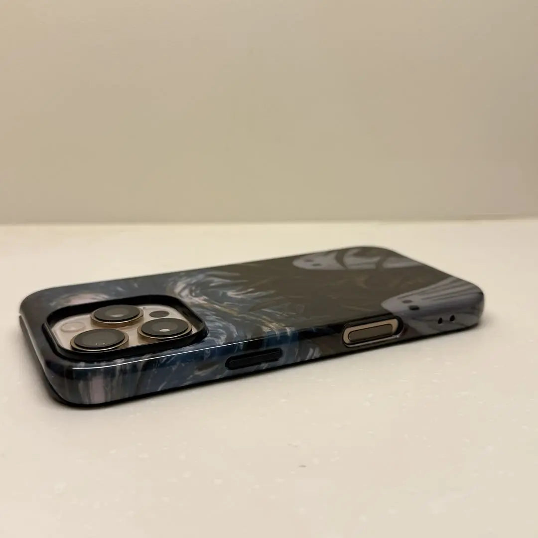 This Halloween phone case features a vintage collage of classic elements like pumpkins, black cats, and skeletons, adding a unique festive vibe.