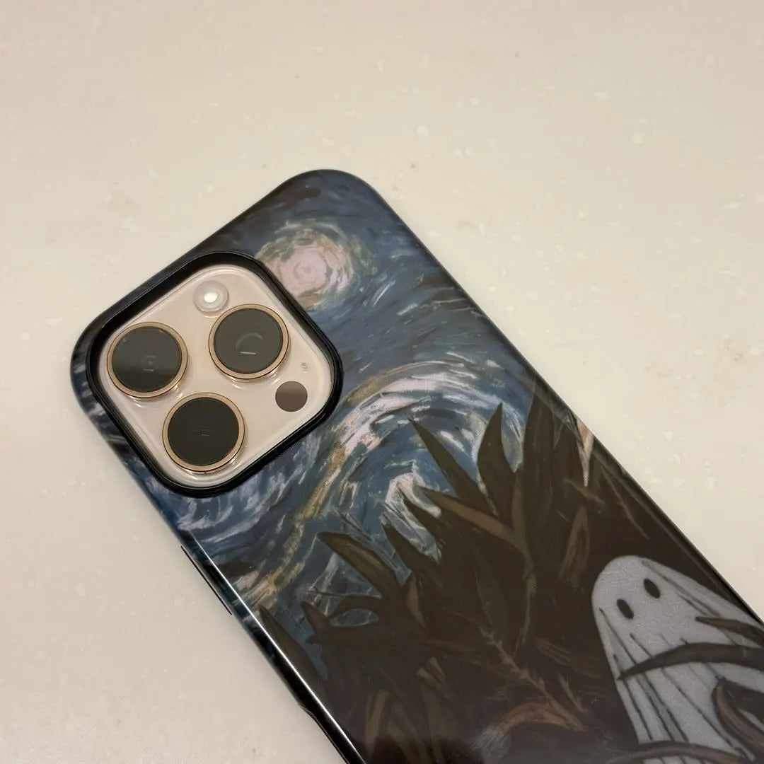 This Halloween phone case features a vintage collage of classic elements like pumpkins, black cats, and skeletons, adding a unique festive vibe.