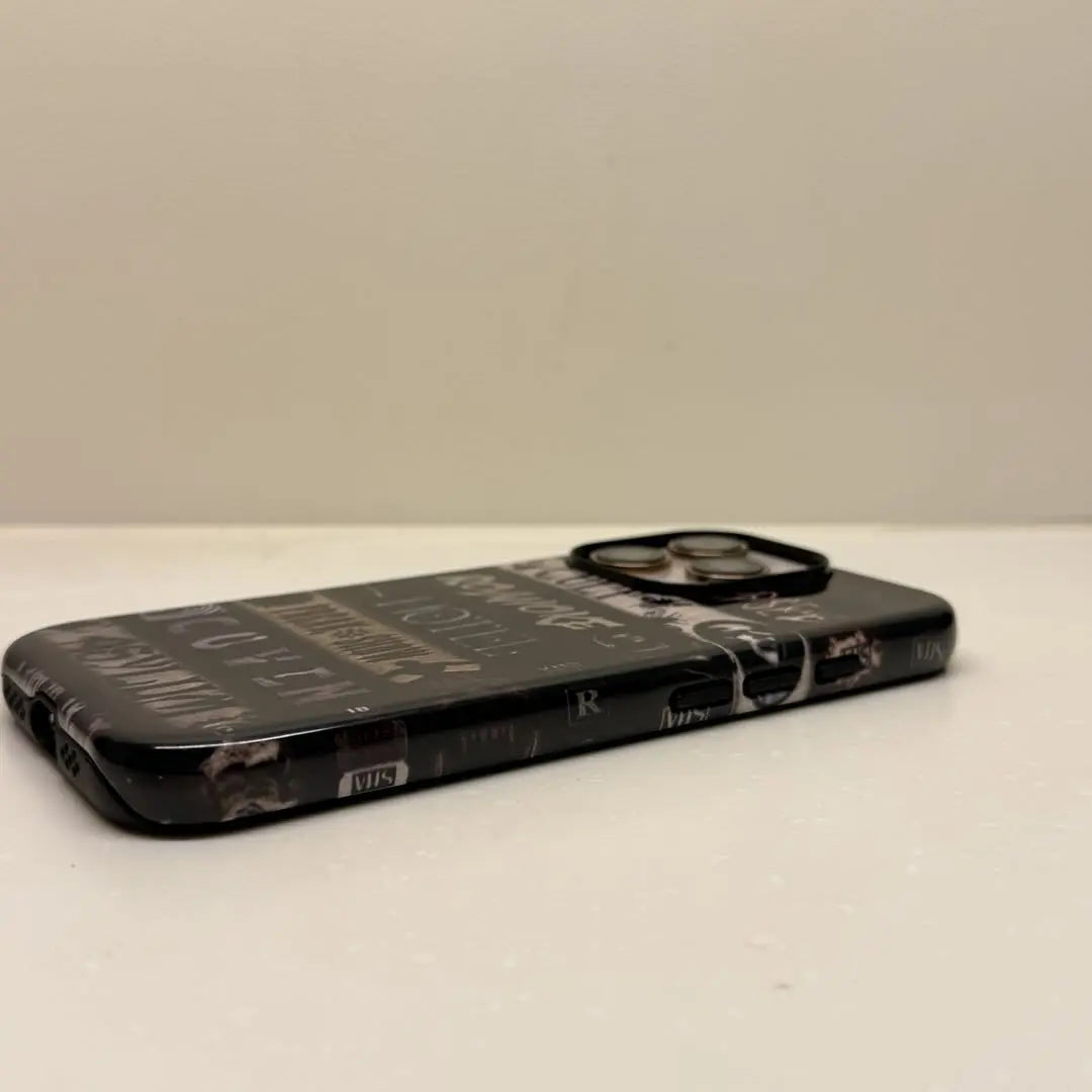 This Halloween phone case features a VHS tape-style design with classic American horror movie titles, making it a unique and must-have item for horror fans.