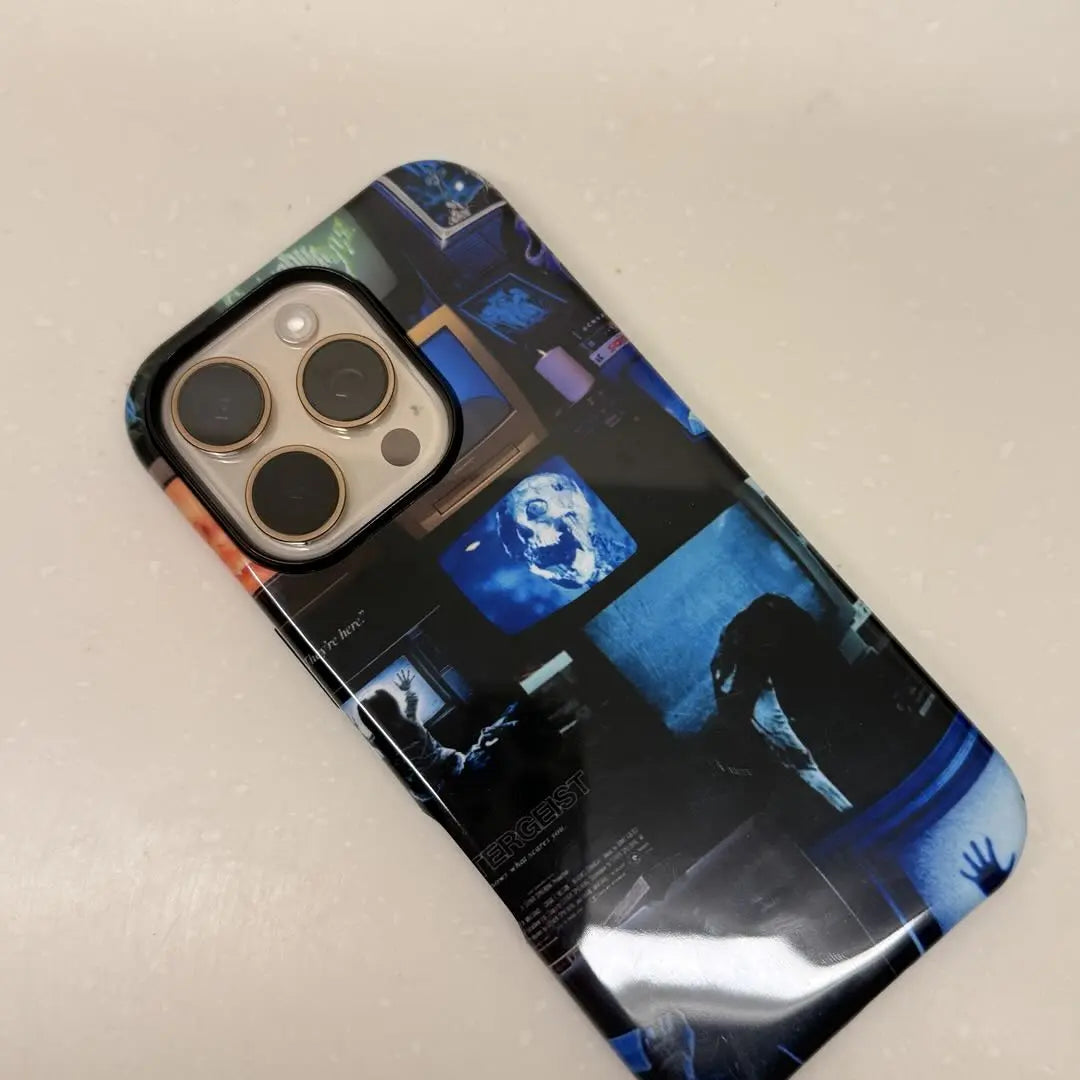 This Halloween phone case features a collage of classic horror movie elements, bringing a trendy vibe that makes it a must-have fashion item for the season.