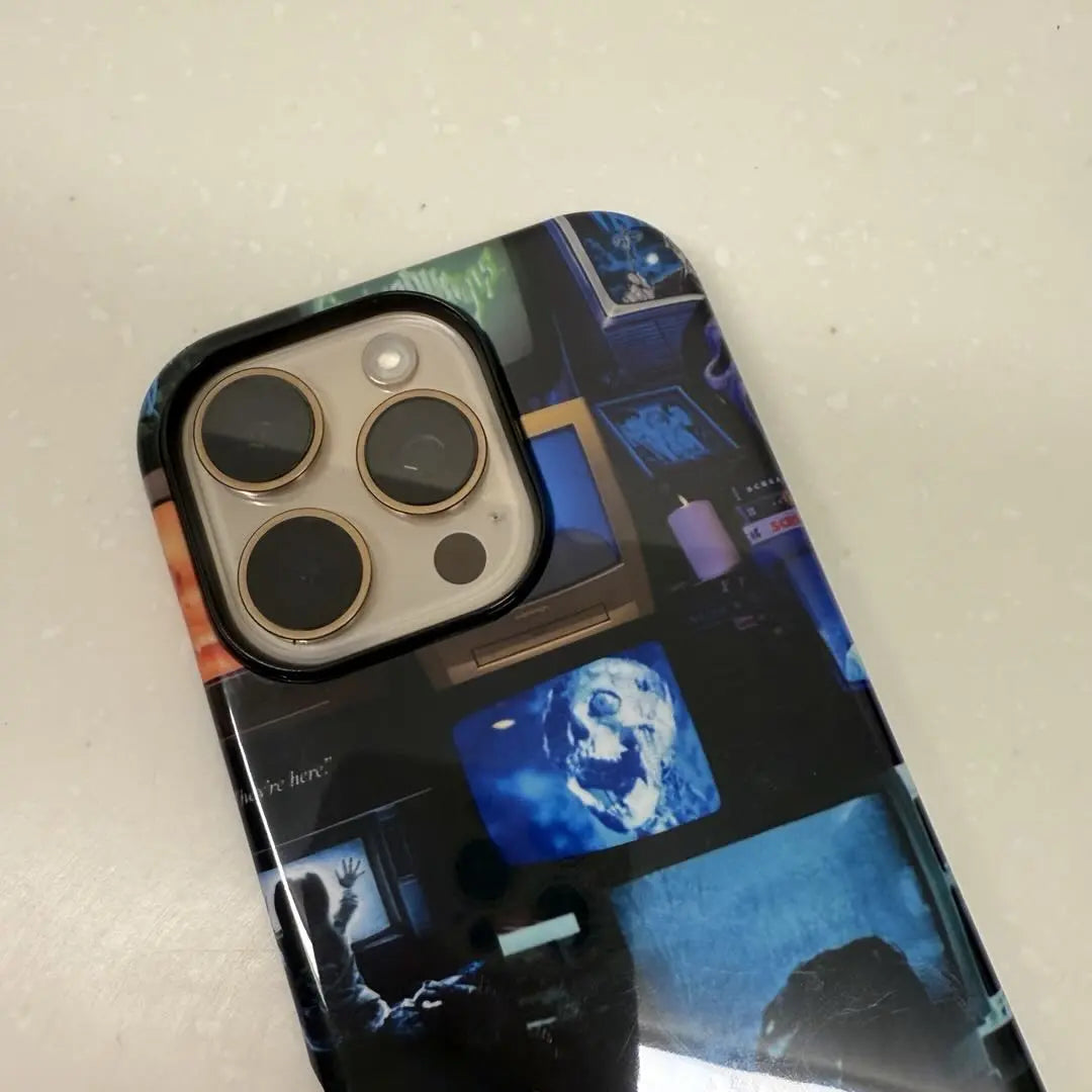 This Halloween phone case features a collage of classic horror movie elements, bringing a trendy vibe that makes it a must-have fashion item for the season.