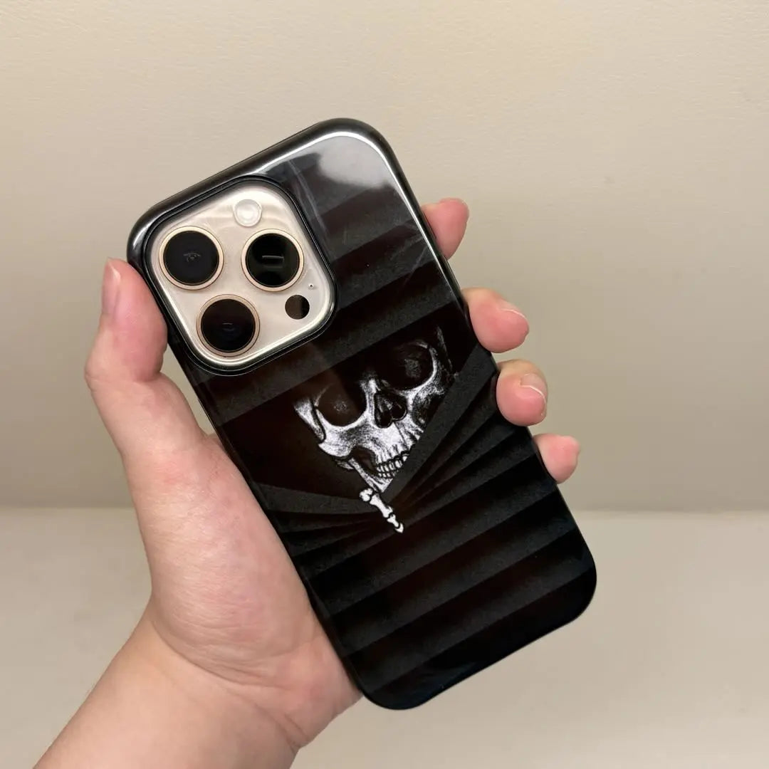 This Halloween phone case features a vintage collage of classic elements like pumpkins, black cats, and skeletons, adding a unique festive vibe.