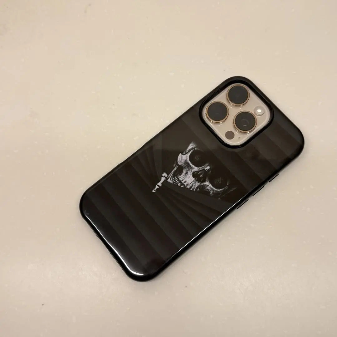 This Halloween phone case features a vintage collage of classic elements like pumpkins, black cats, and skeletons, adding a unique festive vibe.