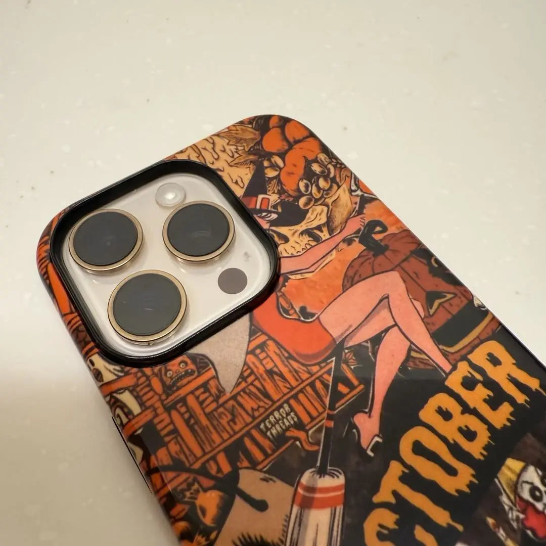 This Halloween phone case features a vintage collage of various horror elements, creating a unique and trendy accessory for the spooky season.