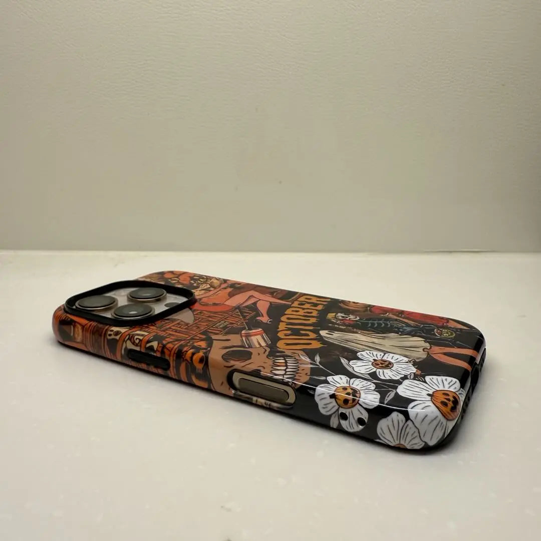 This Halloween phone case features a vintage collage of various horror elements, creating a unique and trendy accessory for the spooky season.