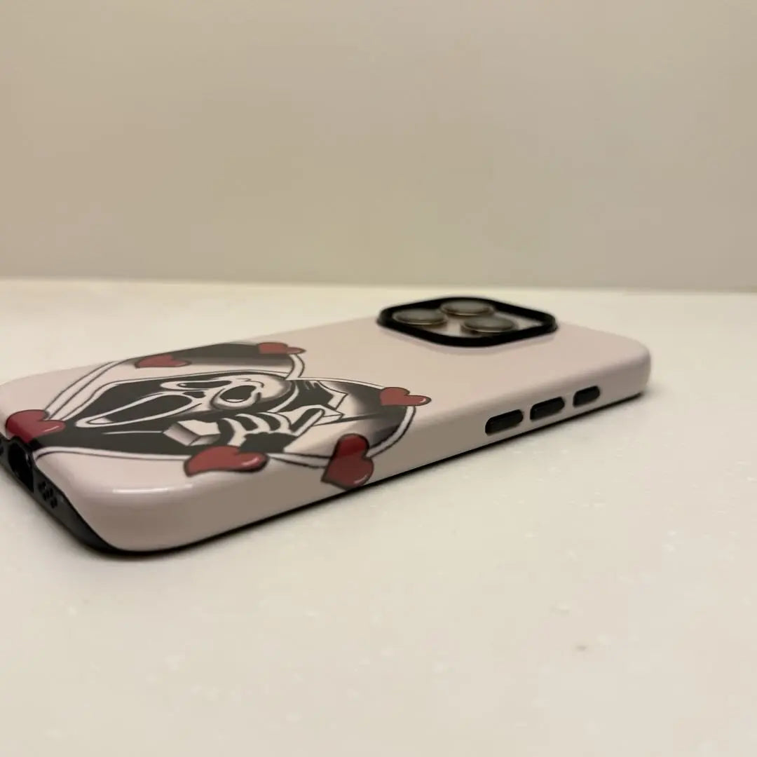 This Halloween phone case features a vintage collage of classic elements like pumpkins, black cats, and skeletons, adding a unique festive vibe.