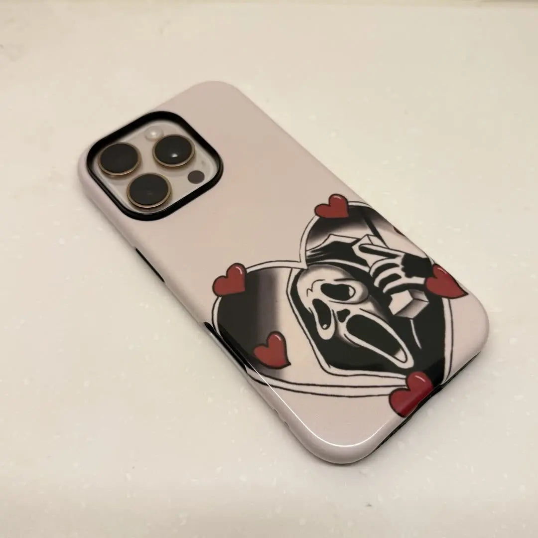 This Halloween phone case features a vintage collage of classic elements like pumpkins, black cats, and skeletons, adding a unique festive vibe.