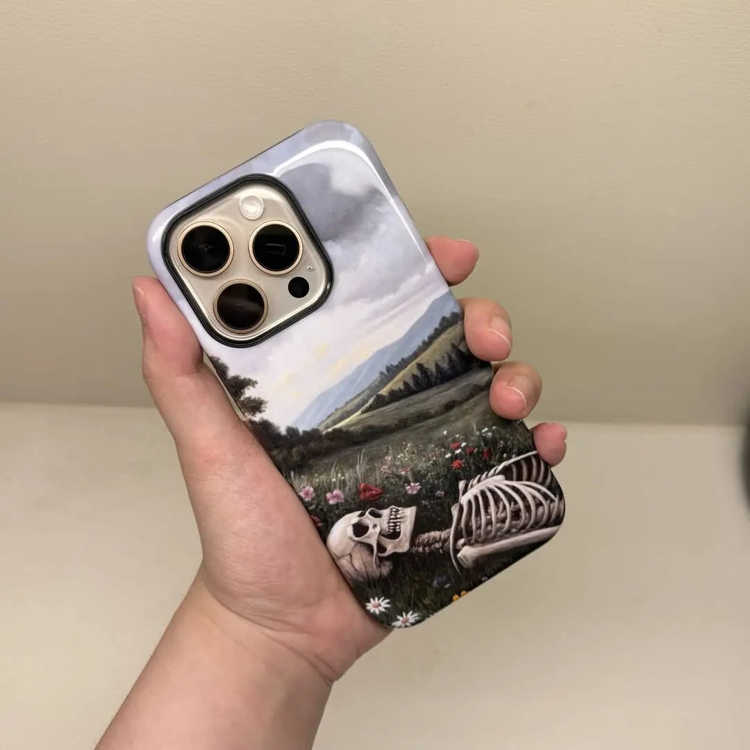 This Halloween phone case features a beautiful oil painting style of a skeleton lying in flowers, blending life and death for a unique artistic touch.