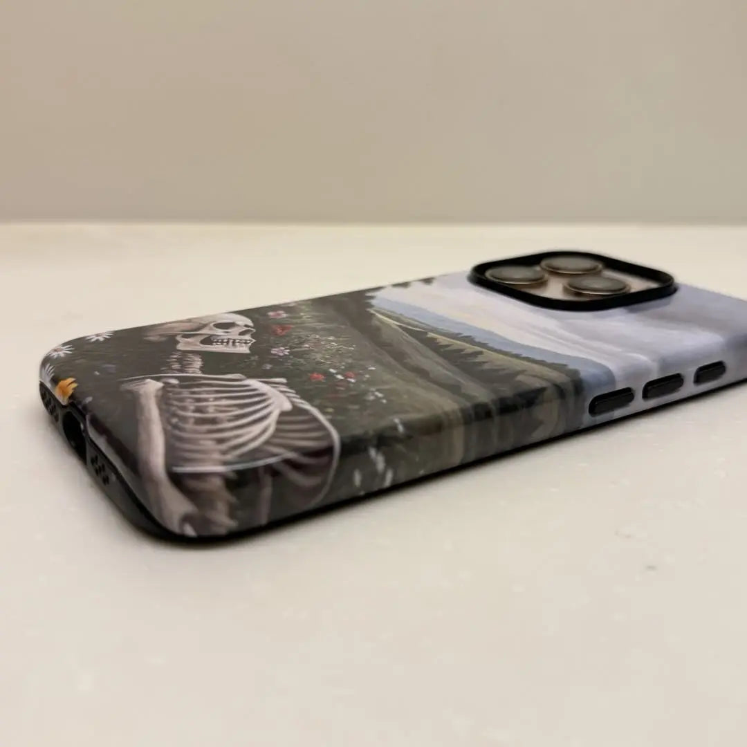This Halloween phone case features a beautiful oil painting style of a skeleton lying in flowers, blending life and death for a unique artistic touch.