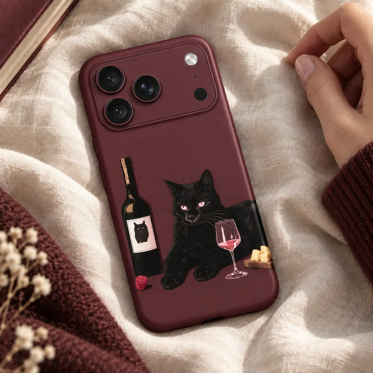 Black cat wine iPhone 18 Pro Max case on ivory linen