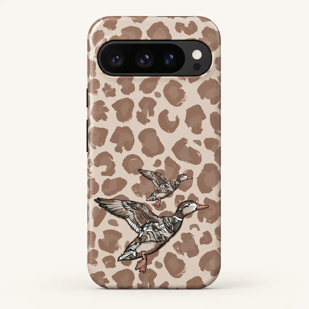 Google Pixel case: beige and taupe leopard spots; two flying ducks, one large and one small.