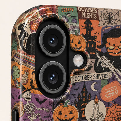 Close-up of the iPhone camera opening surrounded by vintage Halloween pumpkin, black cat and haunted house artwork