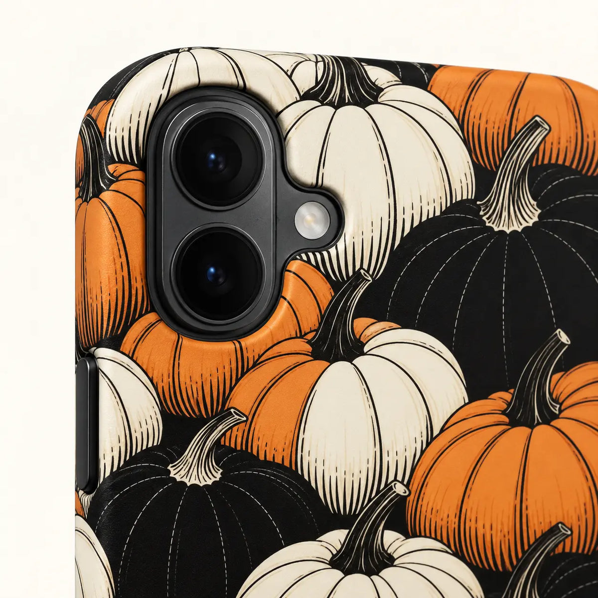 iPhone 16 dual-camera detail on pumpkin-pattern phone case