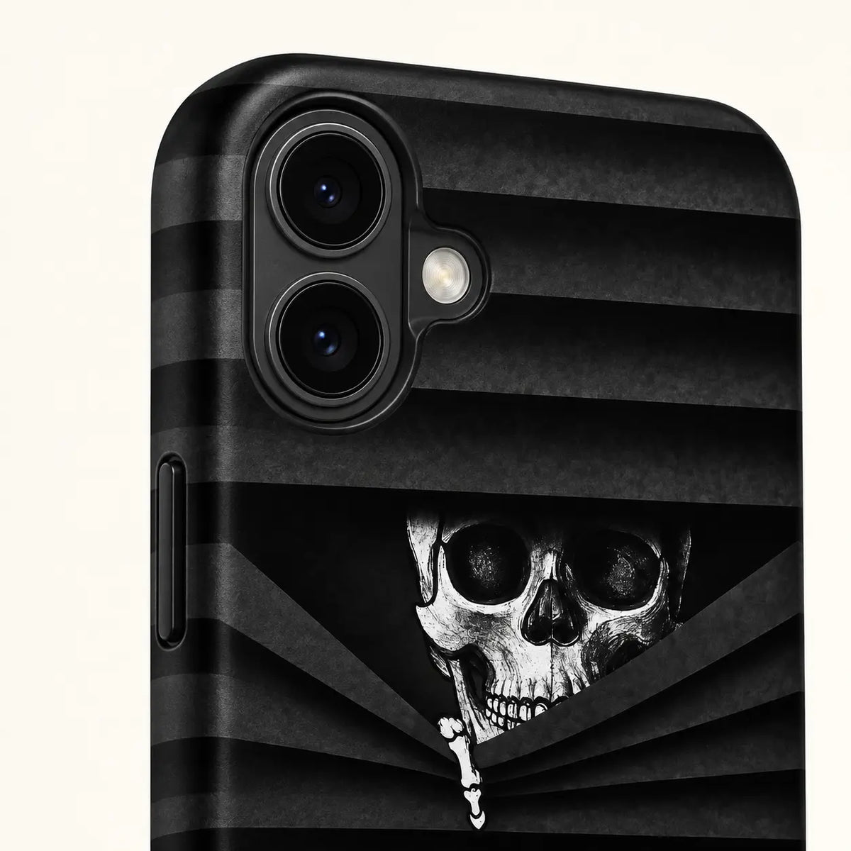 iPhone 16 dual-camera detail on black skull phone case