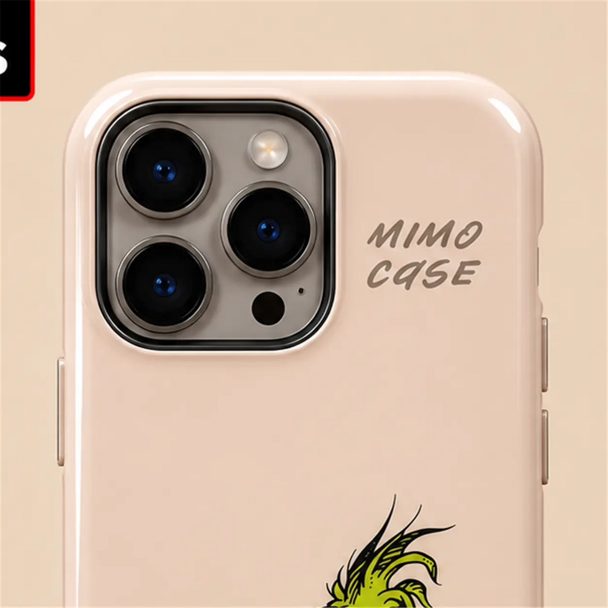 Close-up of raised iPhone camera protection on the blush-pink Grinch Christmas case