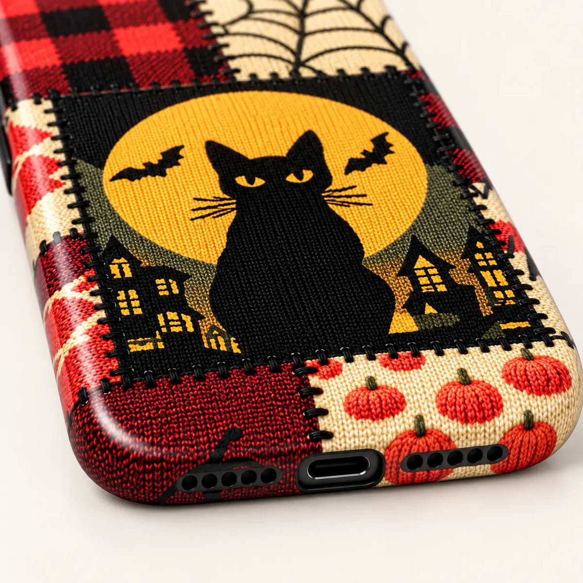 Angled side view of the Halloween patchwork case showing its printed edge and button covers.