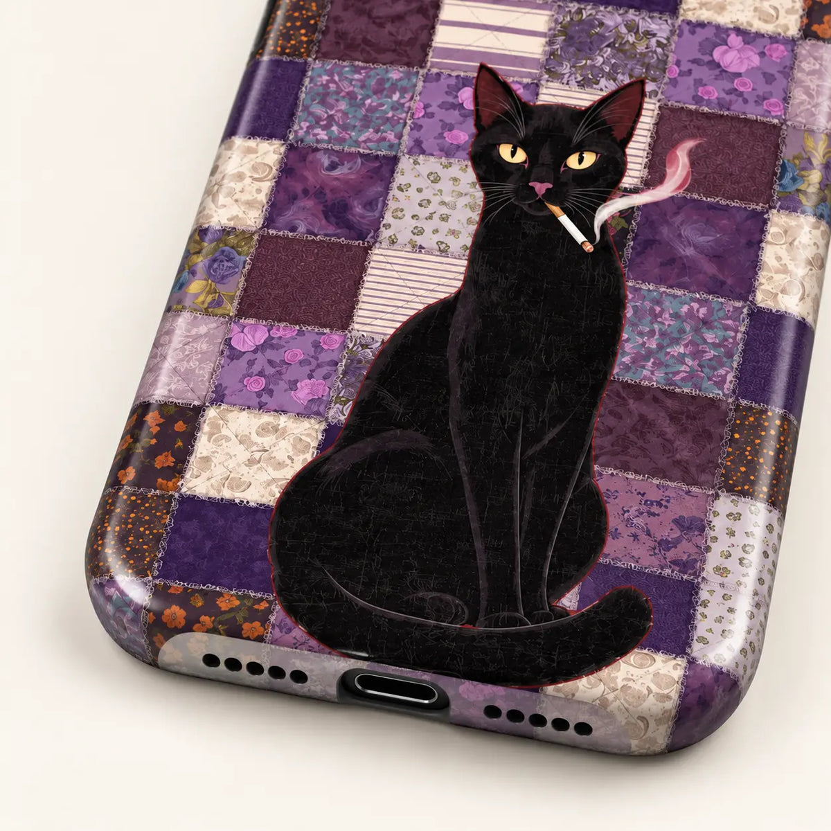 Angled view of the purple patchwork black cat case showing its printed side and button covers.