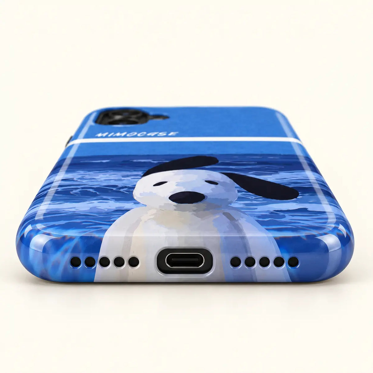 Bottom view of blue dog phone case with USB-C port and ten speaker holes