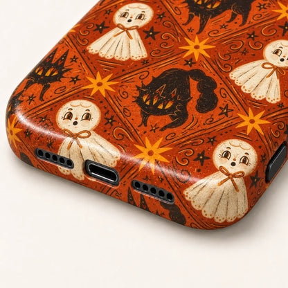 Close-up of the phone case's bottom corners and port openings, with cream ghosts and black cats on an orange background