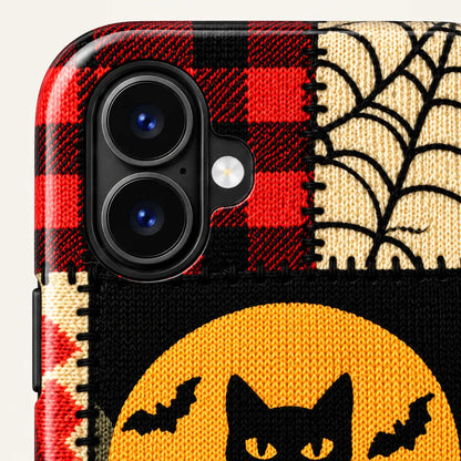 Camera surround close-up with red plaid and cream spiderweb artwork.
