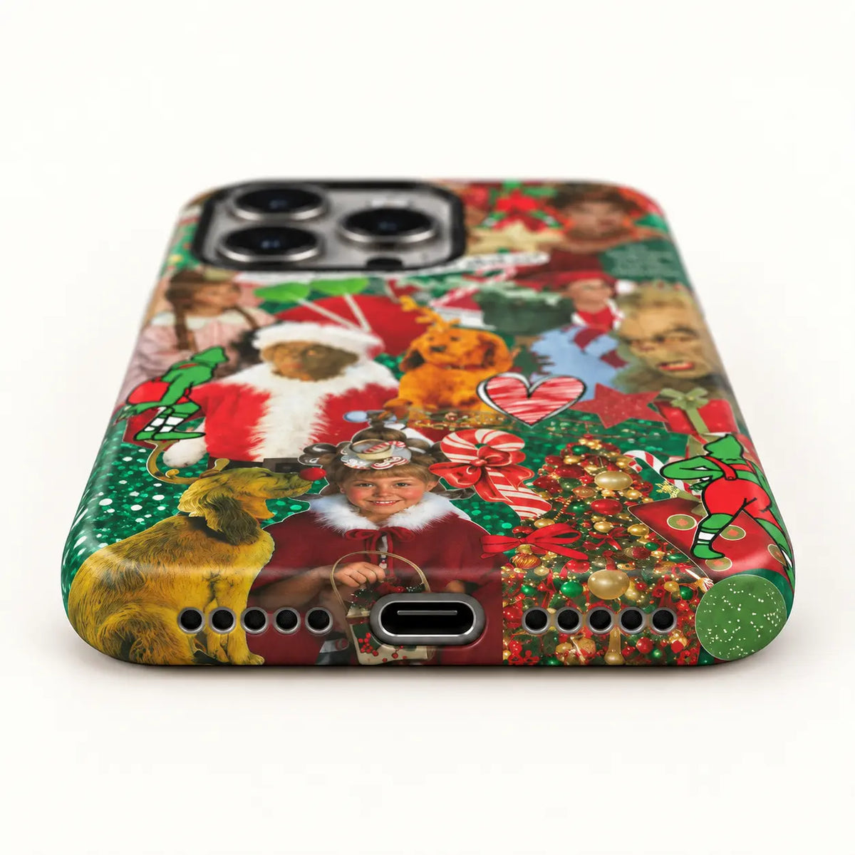 Bottom-port detail of the Christmas collage iPhone case with centered charging port and speaker holes