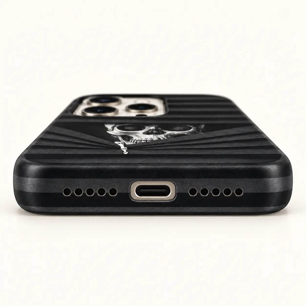 USB-C and speaker opening detail on black striped skull case