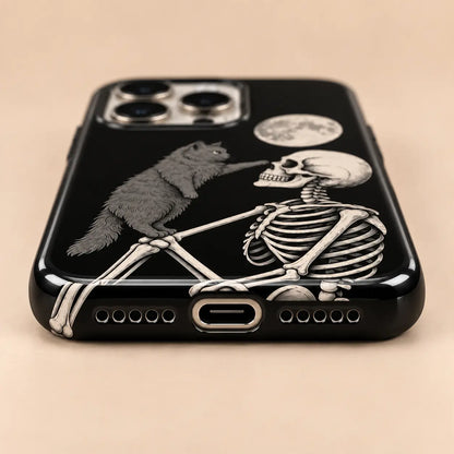 Bottom view of charging port and speaker holes on the Cat and Skeleton iPhone case