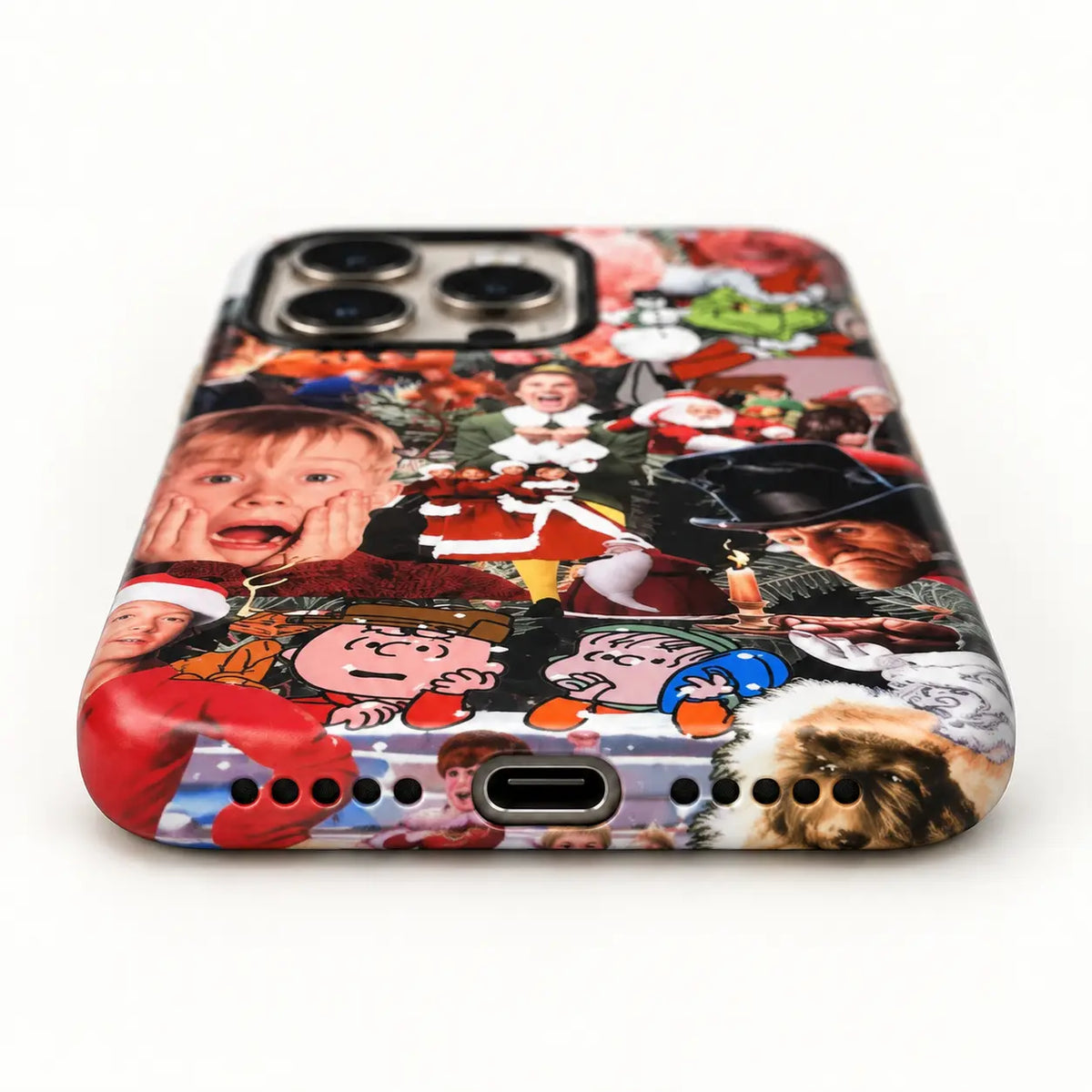 Bottom-port detail of the Christmas collage iPhone case with centered port and speaker holes