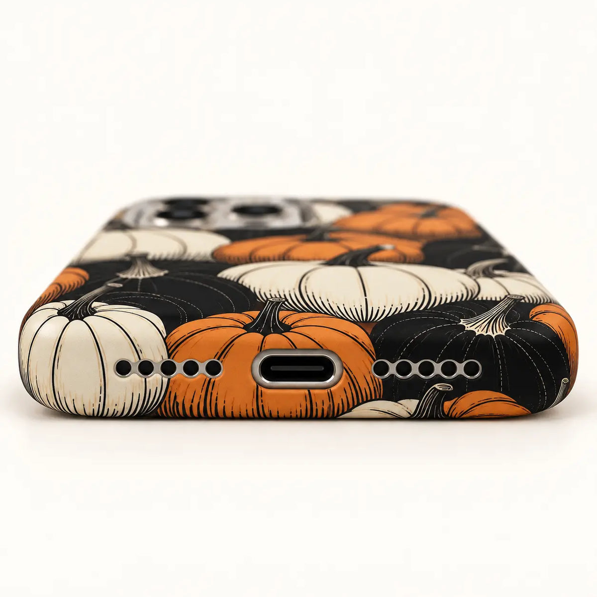USB-C and speaker opening detail on orange black pumpkin case