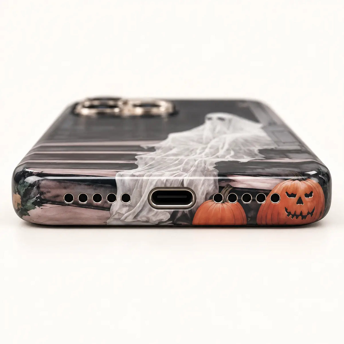 1. Porch Ghost phone case displayed with pumpkins and dark autumn props