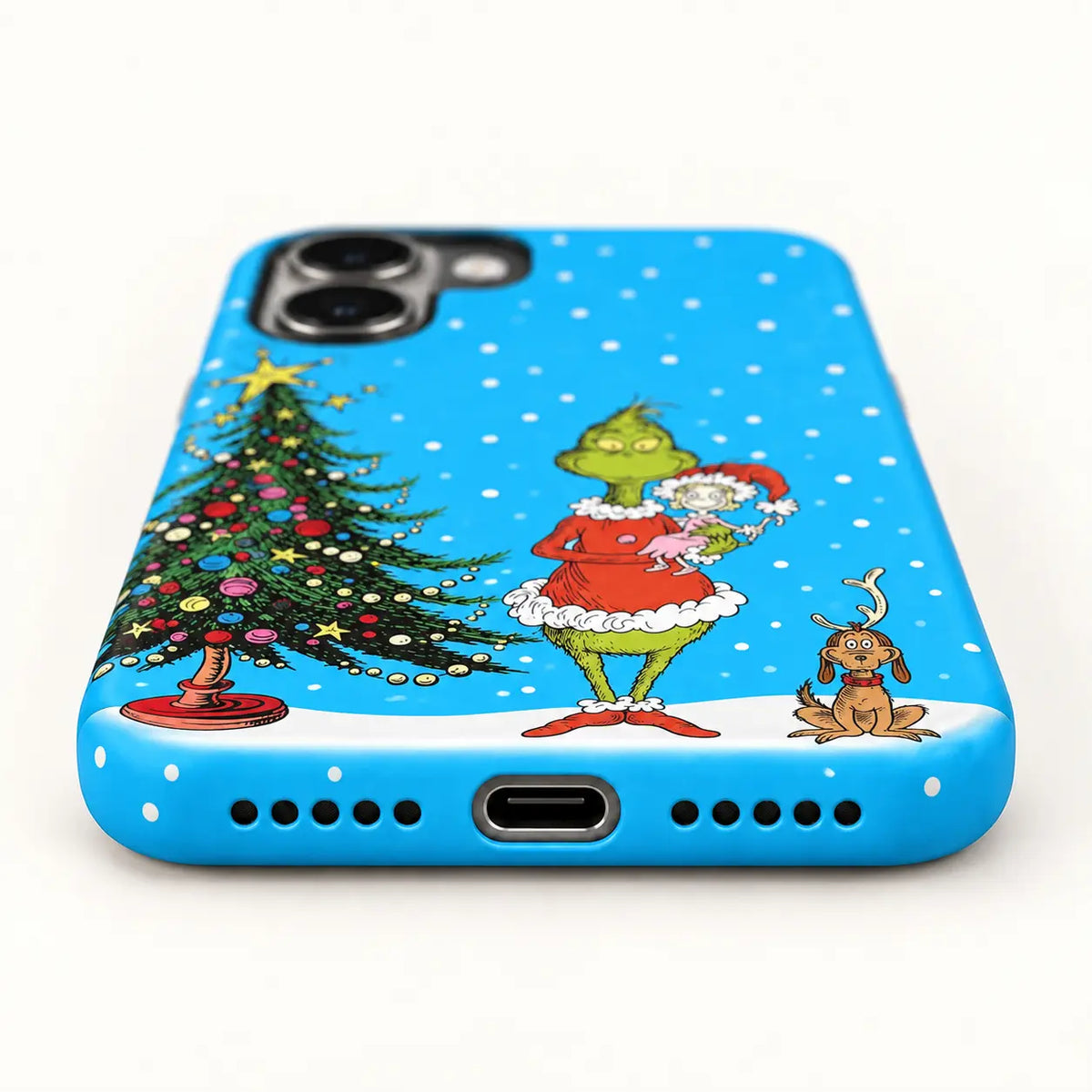 Bottom-port detail of the blue Christmas iPhone case with centered charging port and speaker holes