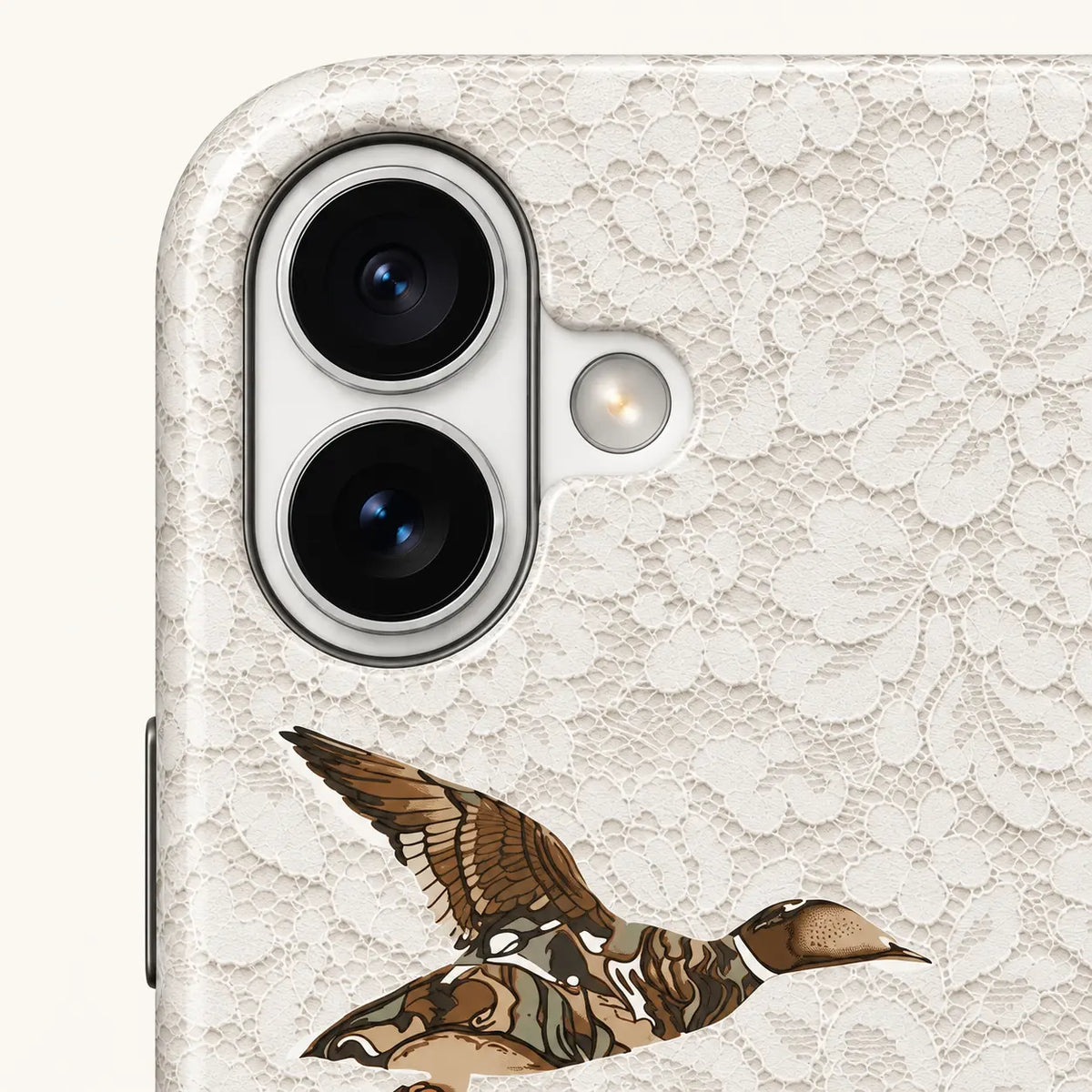iPhone camera-corner close-up showing: white floral lace print.
