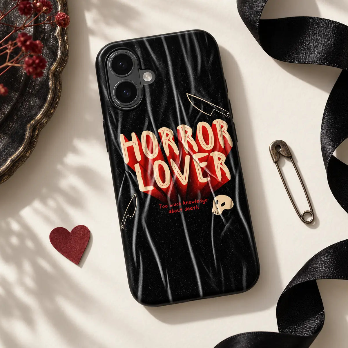 Horror Lover phone case styled with black ribbon, red heart and safety pin
