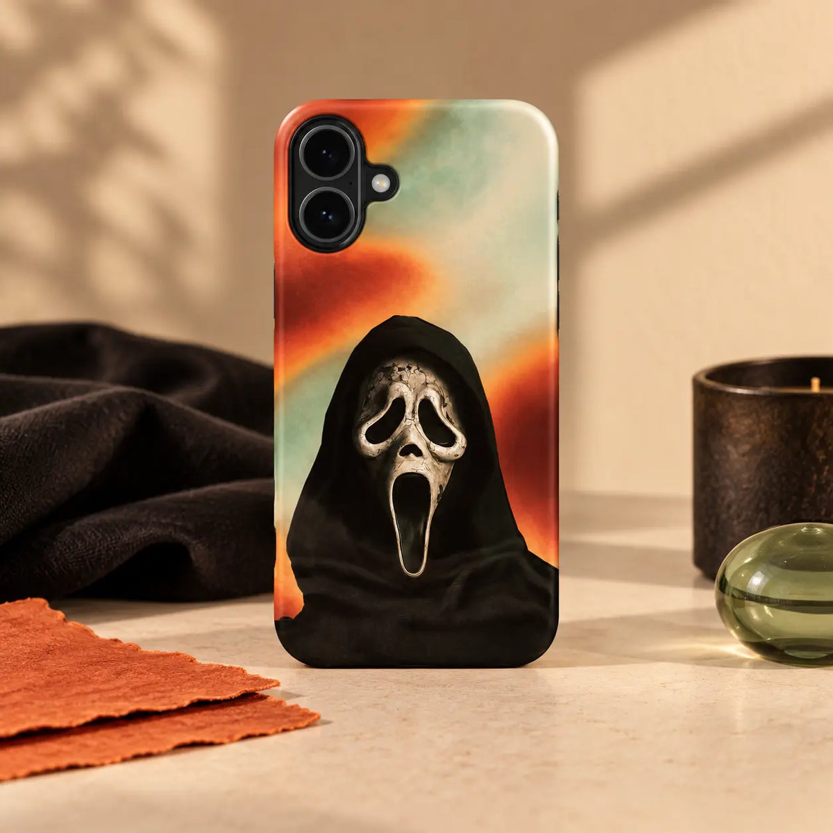 1. Smoky Scream Mask phone case displayed with coordinated dark props