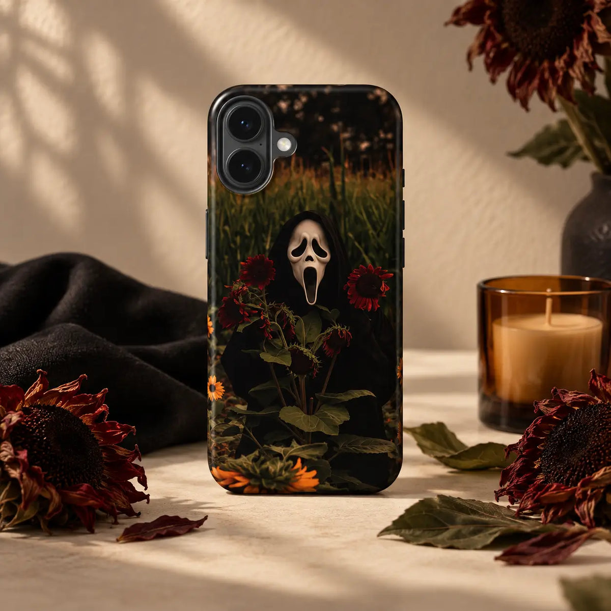 Ghost sunflower Halloween phone case displayed with dried flowers