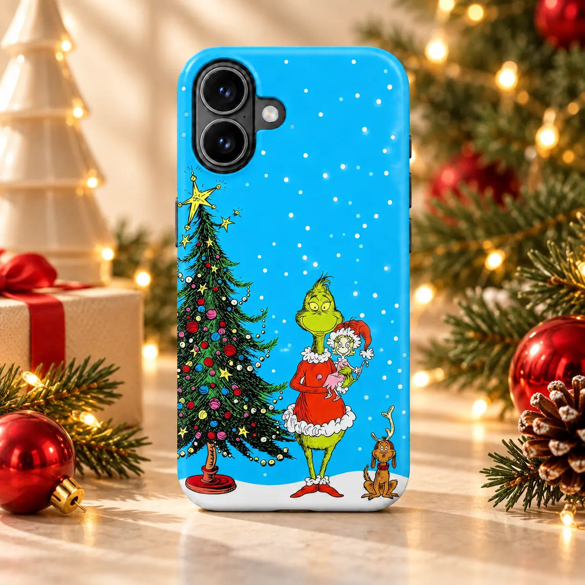 Blue snowy Christmas phone case displayed in a warm festive tabletop setting