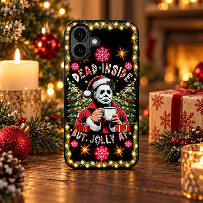 Dead Inside But Jolly Christmas phone case displayed in a warm festive tabletop setting