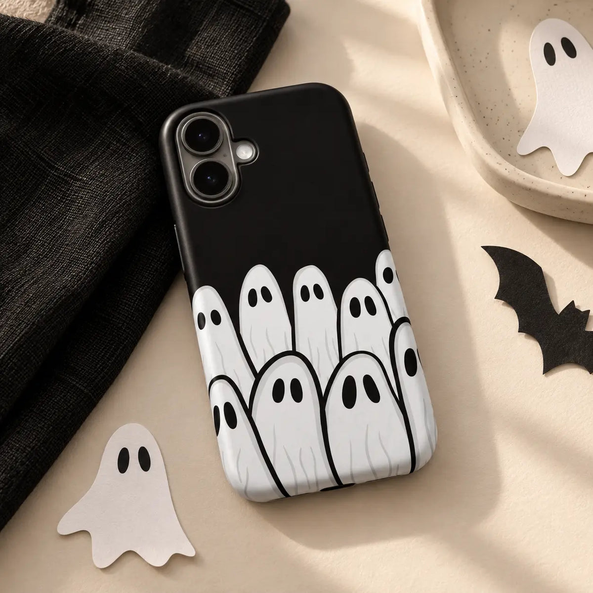 1. A Bunch of Ghosts phone case styled with black fabric and paper Halloween shapes