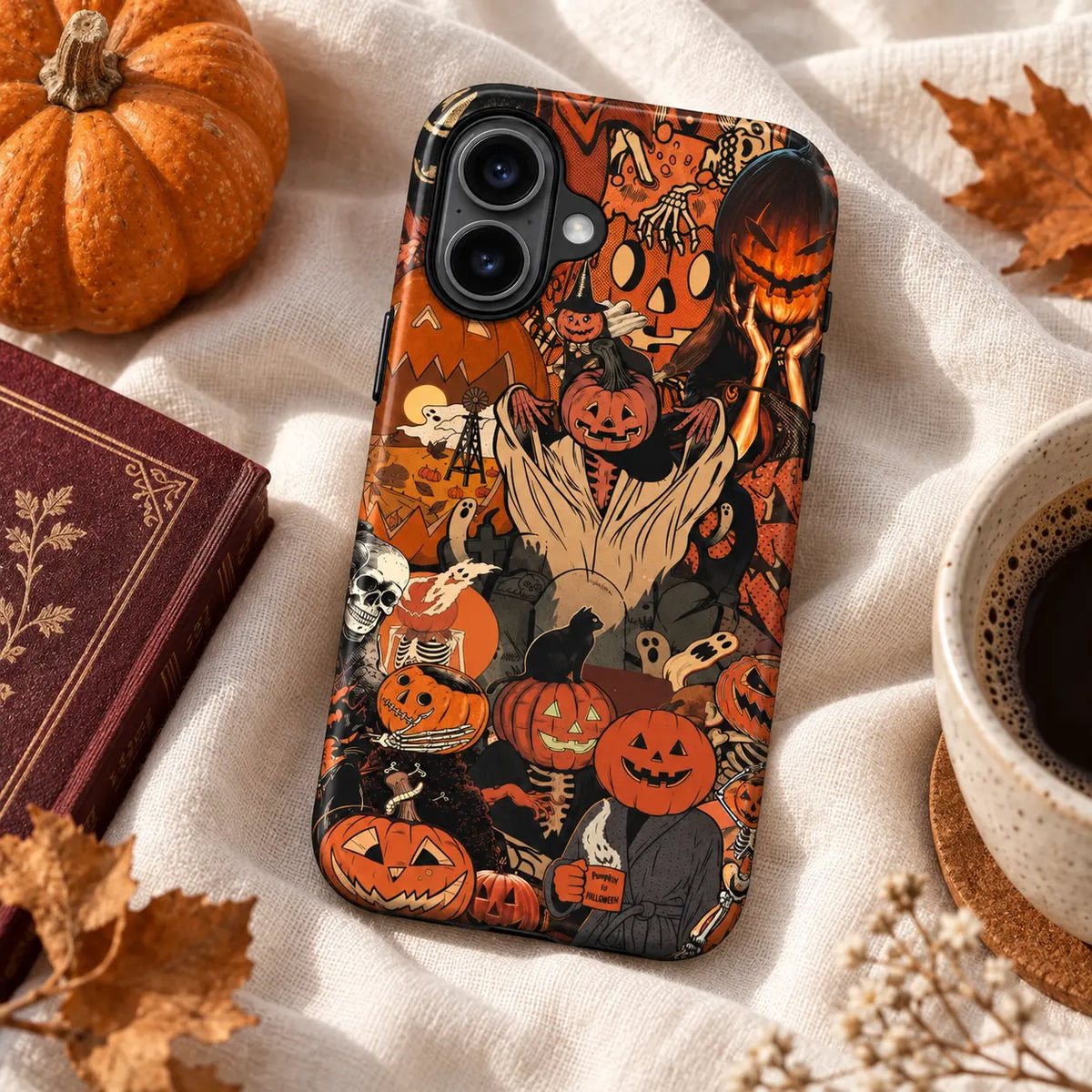 Vintage pumpkin cat phone case displayed on warm autumn linen