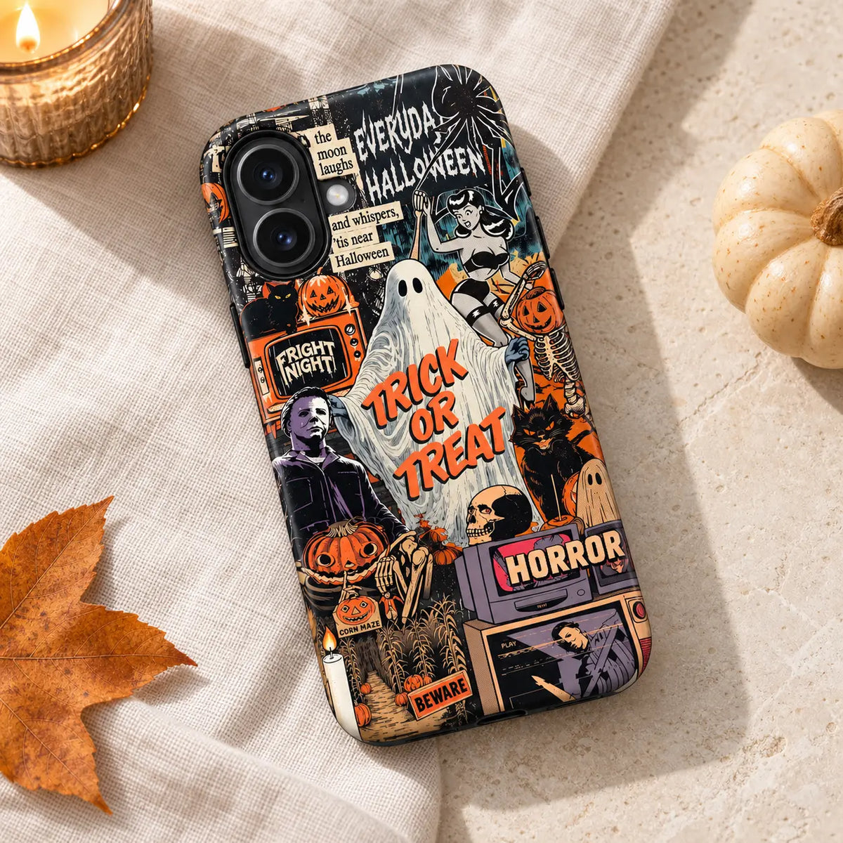 Trick or Treat iPhone case styled with autumn leaves and a cream pumpkin