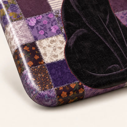 Lower curved corner detail showing the patchwork print and part of the black cat's tail.