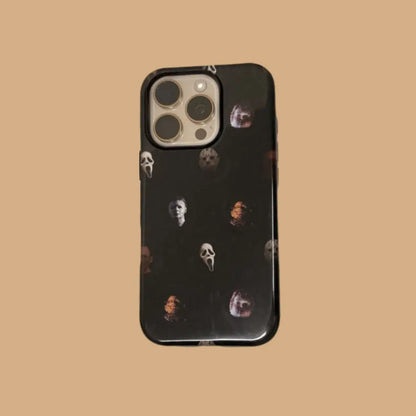 This Halloween phone case features classic horror movie character faces on a black background, offering a subtle yet mysterious vibe for your phone.
