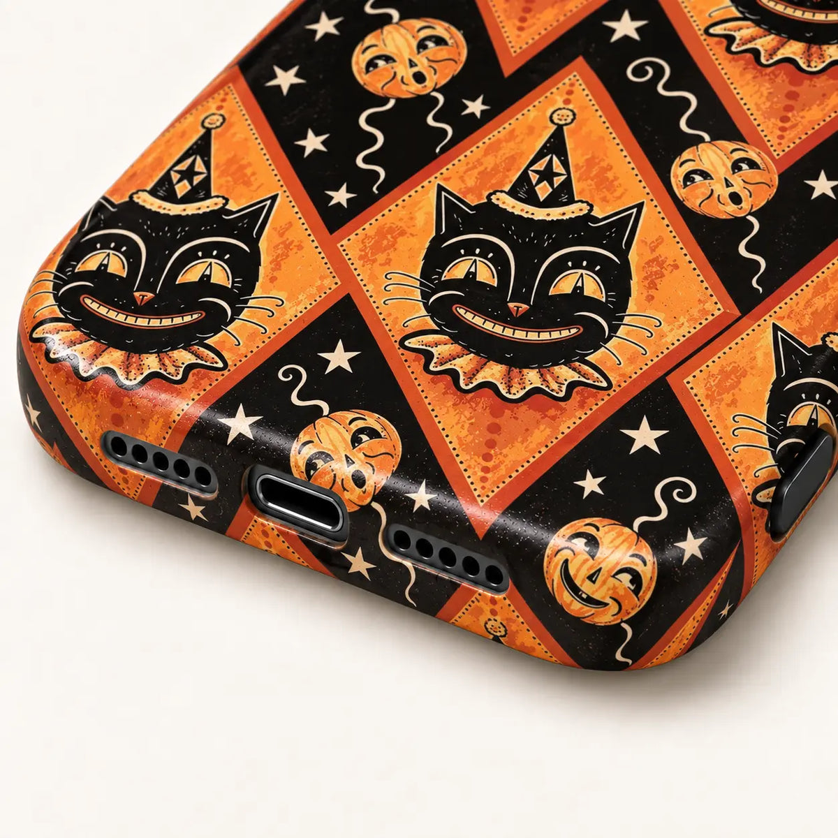 Close-up of the Joker Cat phone case's bottom edge and port openings, with clown cat and pumpkin artwork